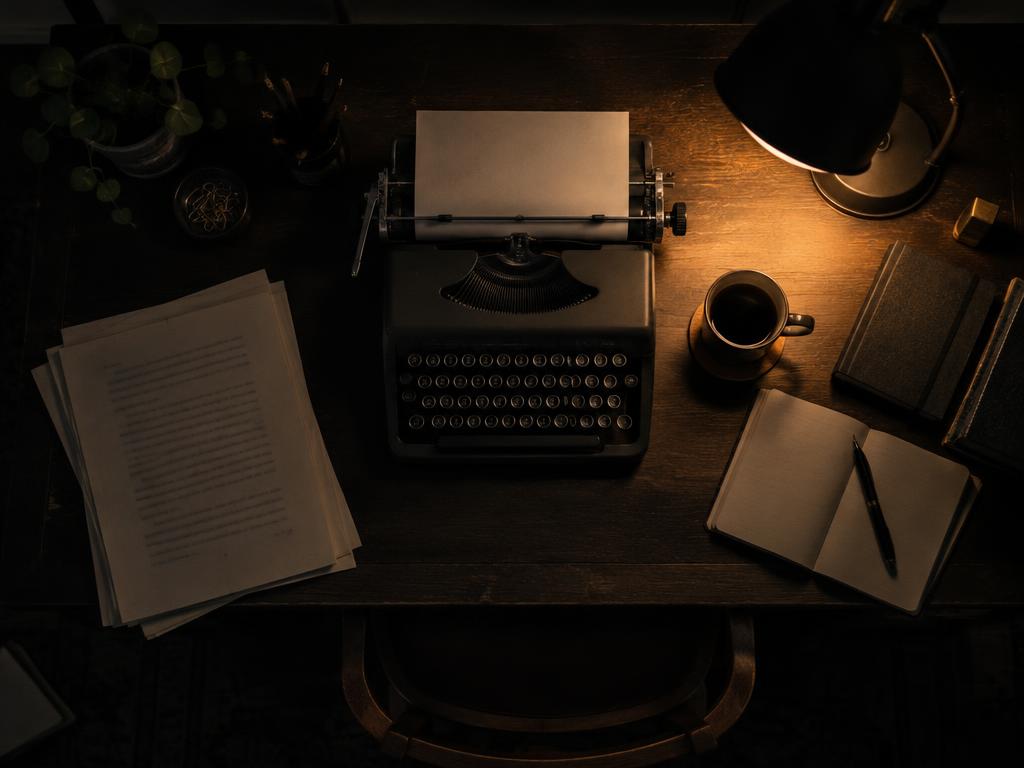 A writer's desk with typewriter and manuscript pages
